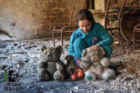 Syria - Children - Girl with dolls in rubble